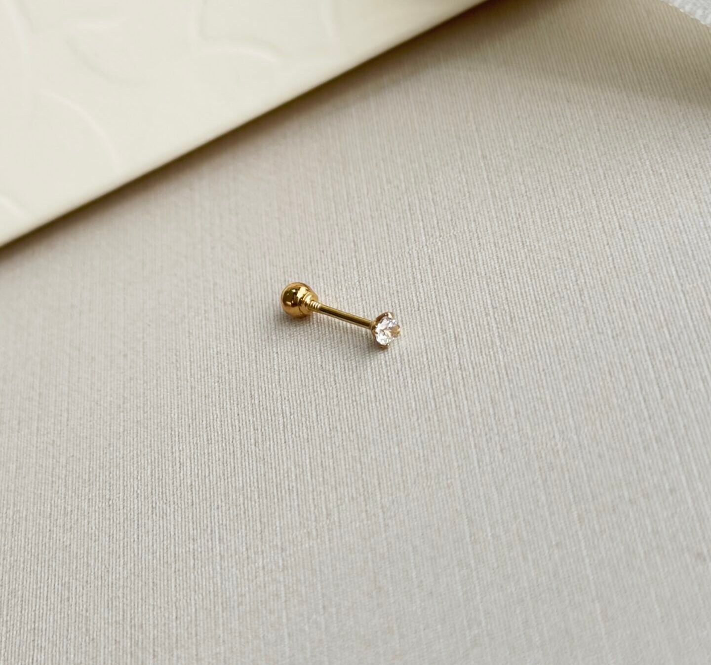 PIERCING EM OURO 18K MICROBELL PONTO DE LUZ